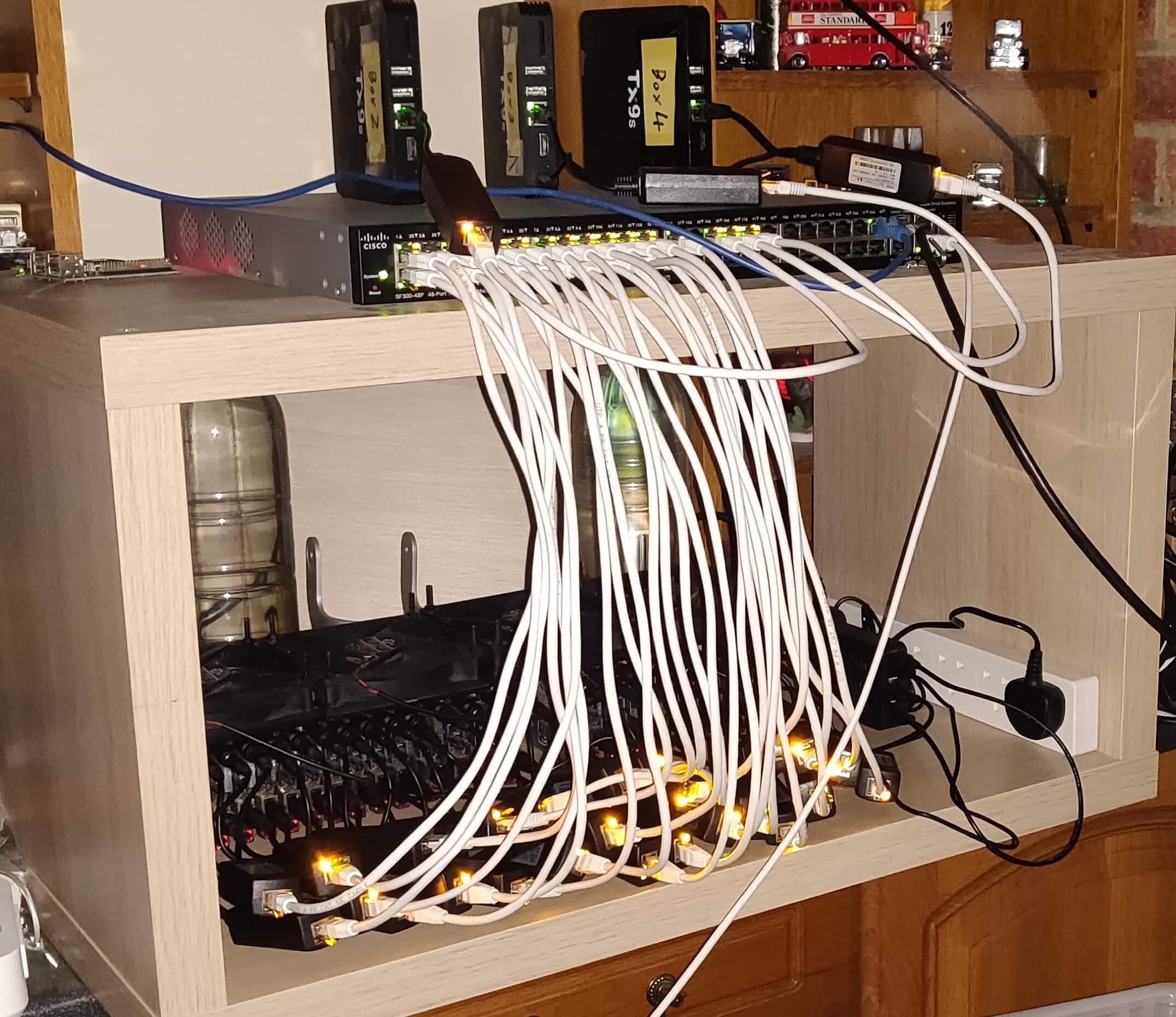 A 32 port Cisco POE Switch supporting a large mix of Android Boxes. All placed inside an IKEA shelf for cleaner storage.